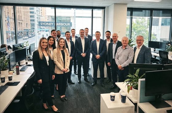 An Australian financial advice team standing together in their office.